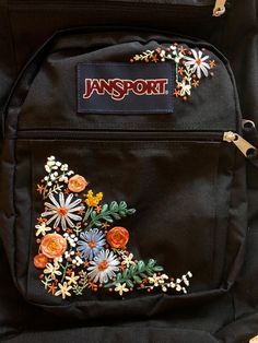 an embroidered backpack with flowers on it