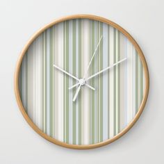 a wall clock with green and white stripes