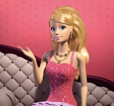 a barbie doll sitting on top of a couch wearing a pink dress and diamond necklaces