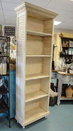 a tall white bookcase sitting inside of a store