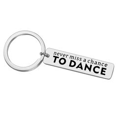 a metal keychain with the words never miss a chance to dance on it