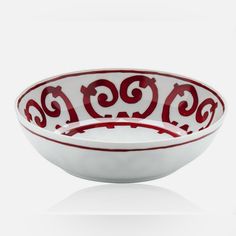 a red and white bowl sitting on top of a table