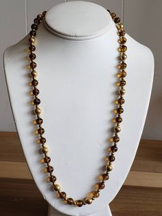 This is a vintage Napier, gold tone metal beads and glass beads necklace. There is a bit of the chain that doesn't have beads on it, as you can see in images. The beads can move on the necklace, slightly. This measures 25.25 inches across. Don't forget to stop in at my other Etsy shop... http://www.etsy.com/shop/xtdesigns. Follow me on Twitter at... MyYiayiaHadThat@MyYiayiaHadThat. If you have a wish list or are looking for something specific, please ask. I may have exactly what you are looking Gold Beaded Long Necklace For Parties, Gold Single Strand Beaded Necklace For Party, Gold Glass Jewelry With Beaded Chain, Gold Necklaces With Spacer Beads For Party, Gold Beaded Long Necklace With Large Beads, Gold Single Strand Beaded Necklace With Round Beads, Gold Long Beaded Necklace With Large Beads, Gold Beads For Long Necklace Party, Gold Long Necklace With Spacer Beads