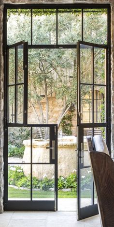 an open glass door leading to a garden