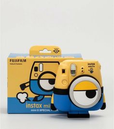 an instax mini camera is shown in front of a box