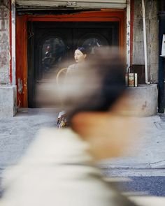 a blurry photo of a woman standing in front of a door