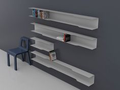 there are three bookshelves on the wall next to a chair