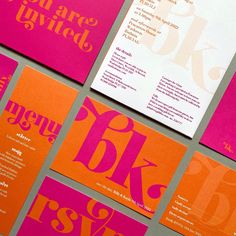 several different types of business cards are displayed on a table with pink and orange designs