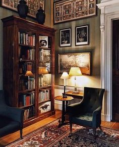 a living room filled with furniture and pictures on the wall