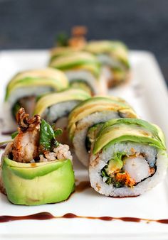 sushi rolls with avocado and shrimp on a white plate