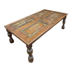 an old wooden table with ornate designs on it