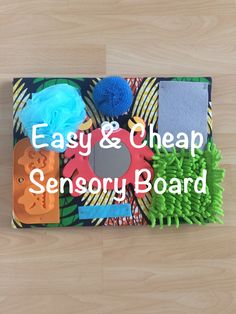 the words easy and cheap sensory board are displayed on a wooden surface with toys