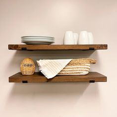 two wooden shelves with plates and bowls on them