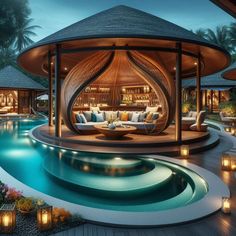 an outdoor living area next to a pool with candles on the ground and lights around it