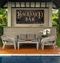 the back yard bar is next to a swimming pool