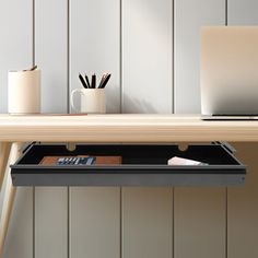 a laptop computer sitting on top of a desk next to a calculator and pen