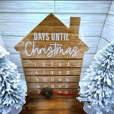 a wooden sign that says days until christmas