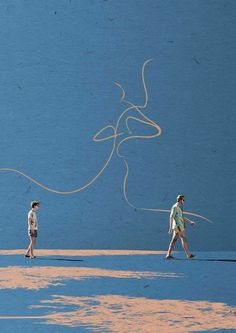 two people are walking on the beach with their kites in hand and one person is holding an orange string