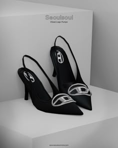 a pair of black high heeled shoes sitting on top of a white box with the word semeloui