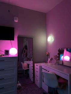 a bedroom with pink lighting and white furniture