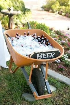 a wheelbarrow filled with bottles of beer