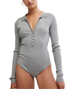 Woman wearing a ribbed, long-sleeve, light gray bodysuit with a deep V-neck and button-up detail, showcasing a minimalist, cozy style. Active Wear Tops, Basic Tees