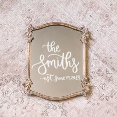 a mirror with the words the smiths on it sitting on top of a table