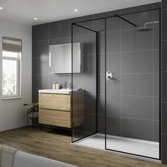 a bathroom with a sink, mirror and shower stall in the middle of the room