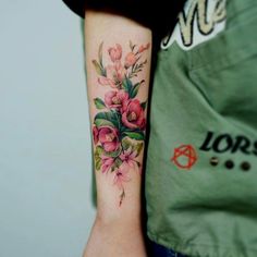 a woman with a flower tattoo on her arm