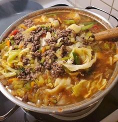 a pot filled with soup sitting on top of a stove