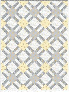 a gray and yellow quilt with squares on it