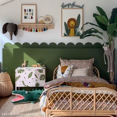 a bedroom decorated in green and white with plants on the wall, bedding and rugs