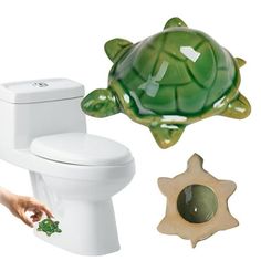 a green turtle sitting on top of a white toilet