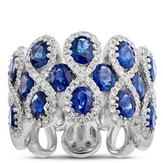 This stunner of a gemstone ring features 14 sapphires surrounded by figure-eight halos of sparkling round diamonds.  The 14k white gold setting is the perfect pairing of precious metal and gemstones because it elegantly complements the deep blue color of the sapphires and light-catching glow of round-cut diamonds. This is truly an heirloom quality piece made to wear and love for a lifetime Argentium Silver Jewelry, Blue Diamond Jewelry, Woman Ring, Round Sapphire, Diamond Fashion Rings, Sapphire And Diamond Ring, Argentium Silver, Precious Metal, Ring Size Guide