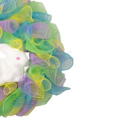 a white bunny in a colorful mesh wreath