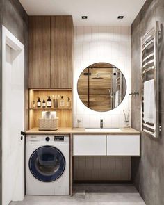 a washer and dryer in a bathroom with wooden cabinetry on the wall