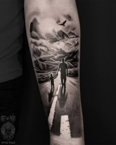 a man with a child walking down the road in front of an airplane tattoo on his arm