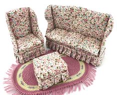 two couches and a rug on a white surface with pink fringes around them