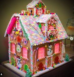 a gingerbread house with candy decorations on the roof