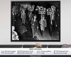 black and white photograph of men walking down the street holding signs that read we want beer