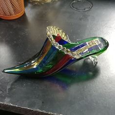 a colorful glass shoe sitting on top of a table