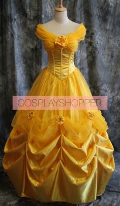 a yellow dress with the words beauty and the beast below it