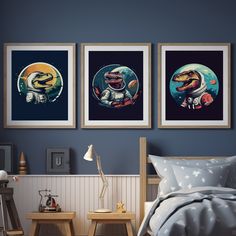 three framed pictures hang on the wall above a bed in a room with blue walls