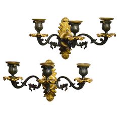 a set of four ornately decorated wall sconces