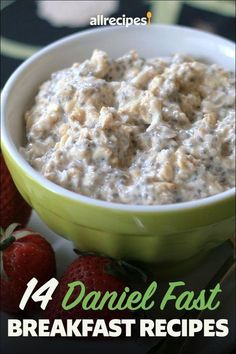 a green bowl filled with oatmeal next to strawberries