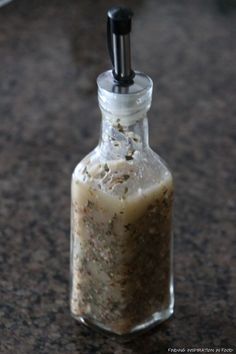 a bottle filled with sand sitting on top of a counter