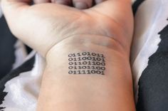 a person's arm with a tattoo on it that has numbers printed on it