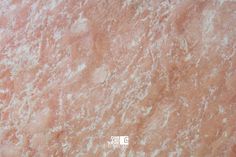 a close up view of a pink marble surface