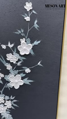 a card with white flowers and leaves on a black background that reads, meson art