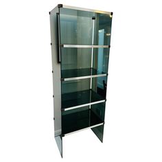 a tall glass display case sitting on top of a white floor